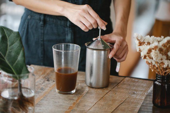 Cold Brew Coffee Tips, Level Up Your Skills like a Pro, a person preparing a cup of cold brew coffee