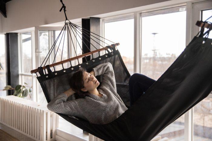 Caffeine's Impact on Sleep How to Keep it Under Control, a woman sleeping in a hammock